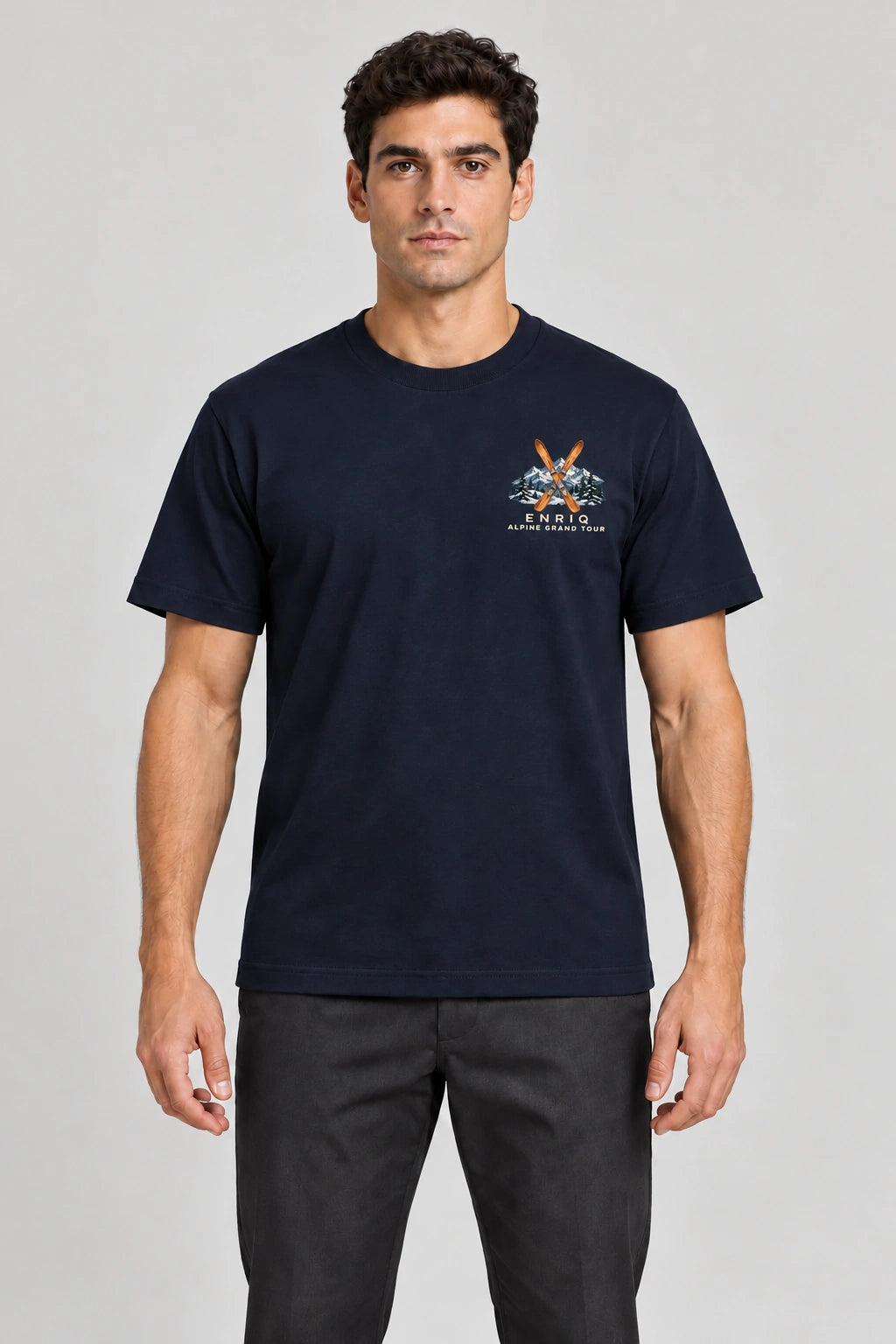 ENRIQ Alpine Grand Tour Tee Navy – op model met ski- en bergborstlogo (AI-visualisatie)